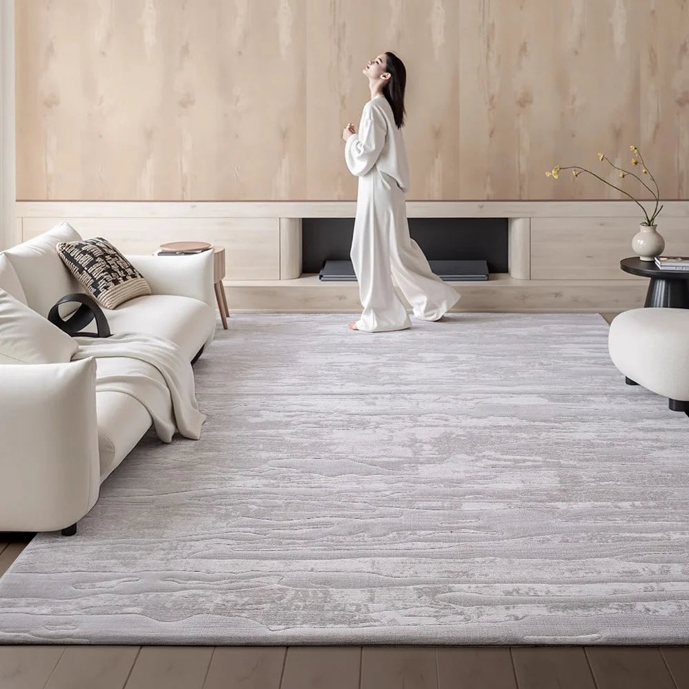 Modern minimalist area rug in a bright living room creating a calm and comfortable atmosphere