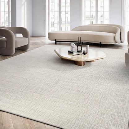 Modern minimalist light cream wool rug in a spacious living room with elegant beige furniture and natural light.