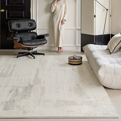 A softly textured neutral rug grounds a minimalist yet luxurious living space, featuring iconic furniture and clean architectural lines for a serene modern vibe