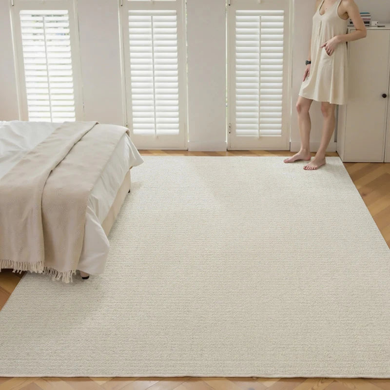 Eco-friendly natural wool rug in a minimalist bedroom, featuring soft cream tones and cozy woven texture for a warm and inviting atmosphere