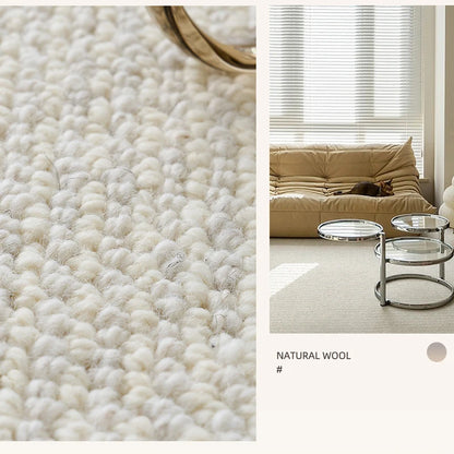 Close-up of natural wool loop texture rug paired with modern beige sofa and round glass coffee tables in a sunlit room
