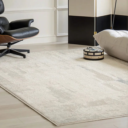 Neutral-toned rug with abstract textures in a contemporary living room, paired with a luxury lounge chair and minimal decor.