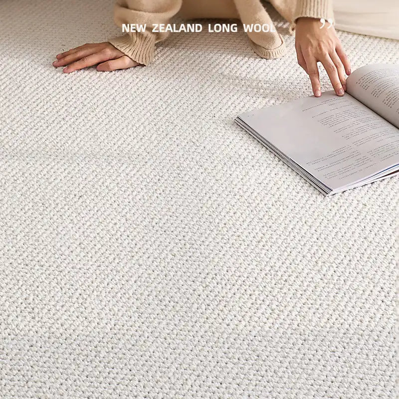 Close-up of a soft New Zealand long wool rug with a person reading on it.