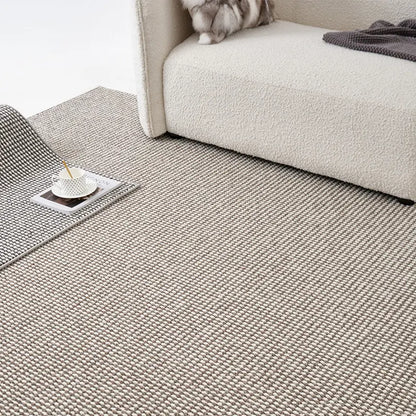 Minimalist pebble loop wool blend rug in natural beige and grey tones, soft and dense weave