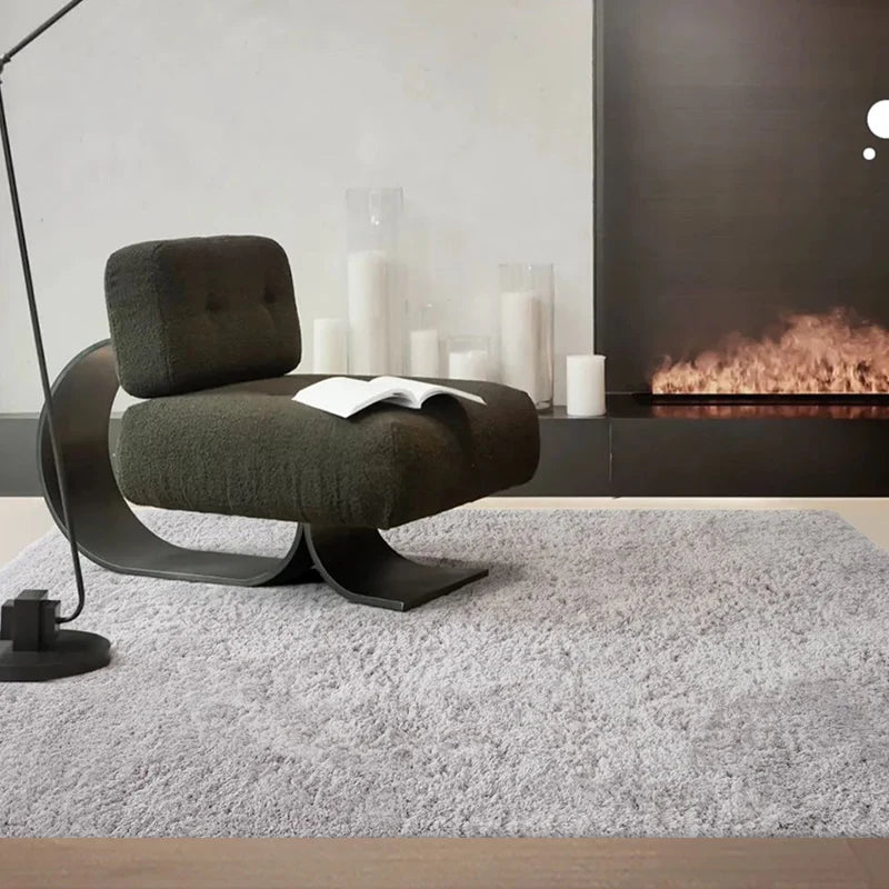 Cozy gray shaggy rug paired with a modern chair in front of a sleek fireplace #color_Light Gray