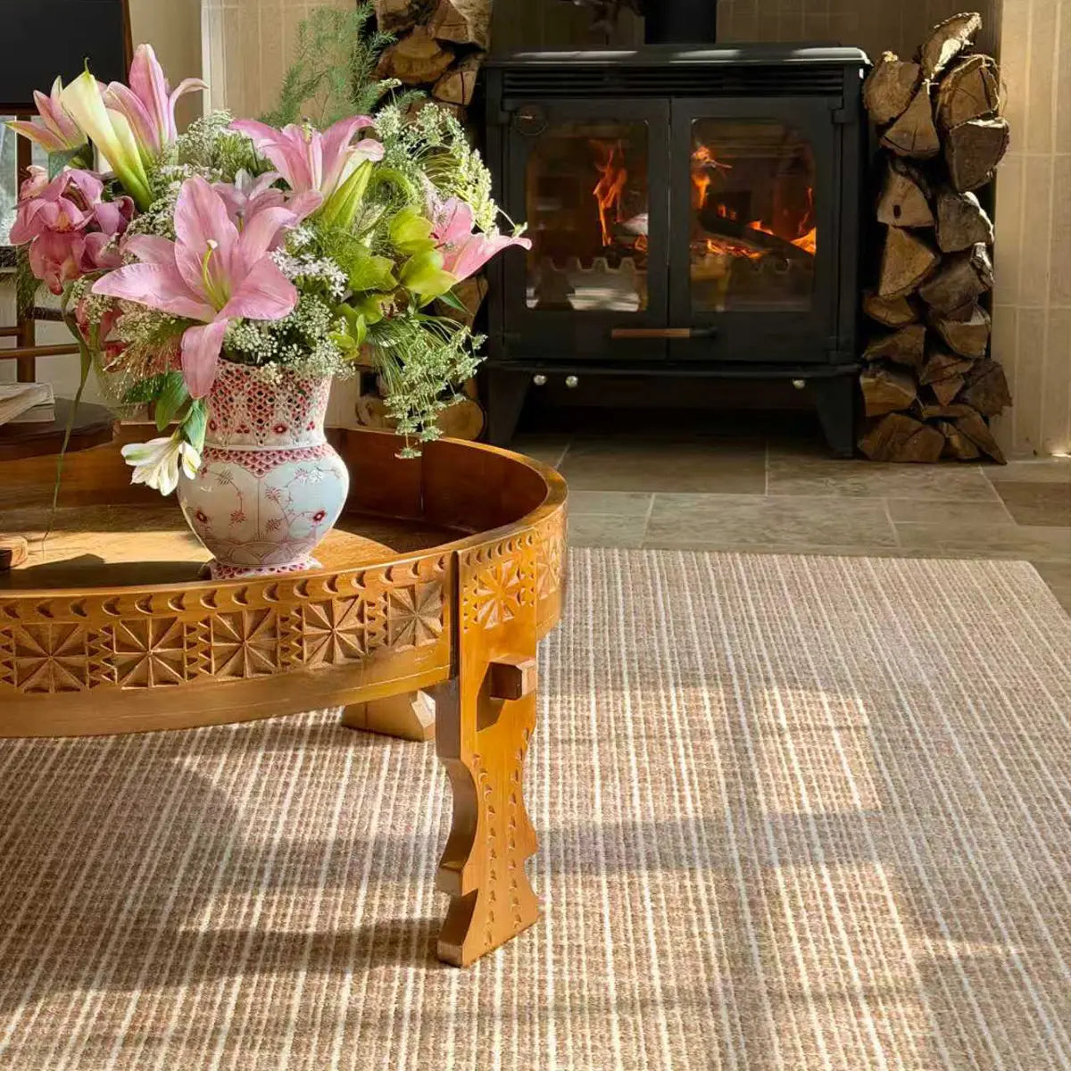 Brown beige textured Siena rug beside a wood coffee table and fireplace