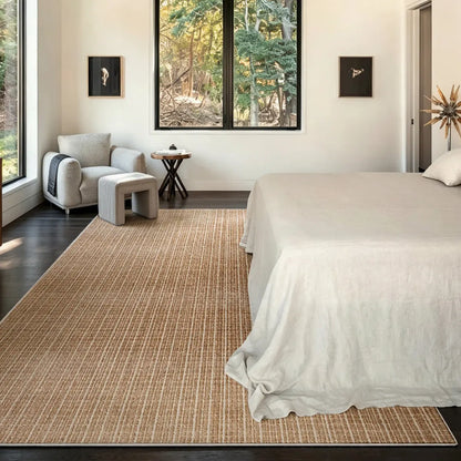 Siena light brown beige rug in a neutral bedroom with white bedding and dark wood floors