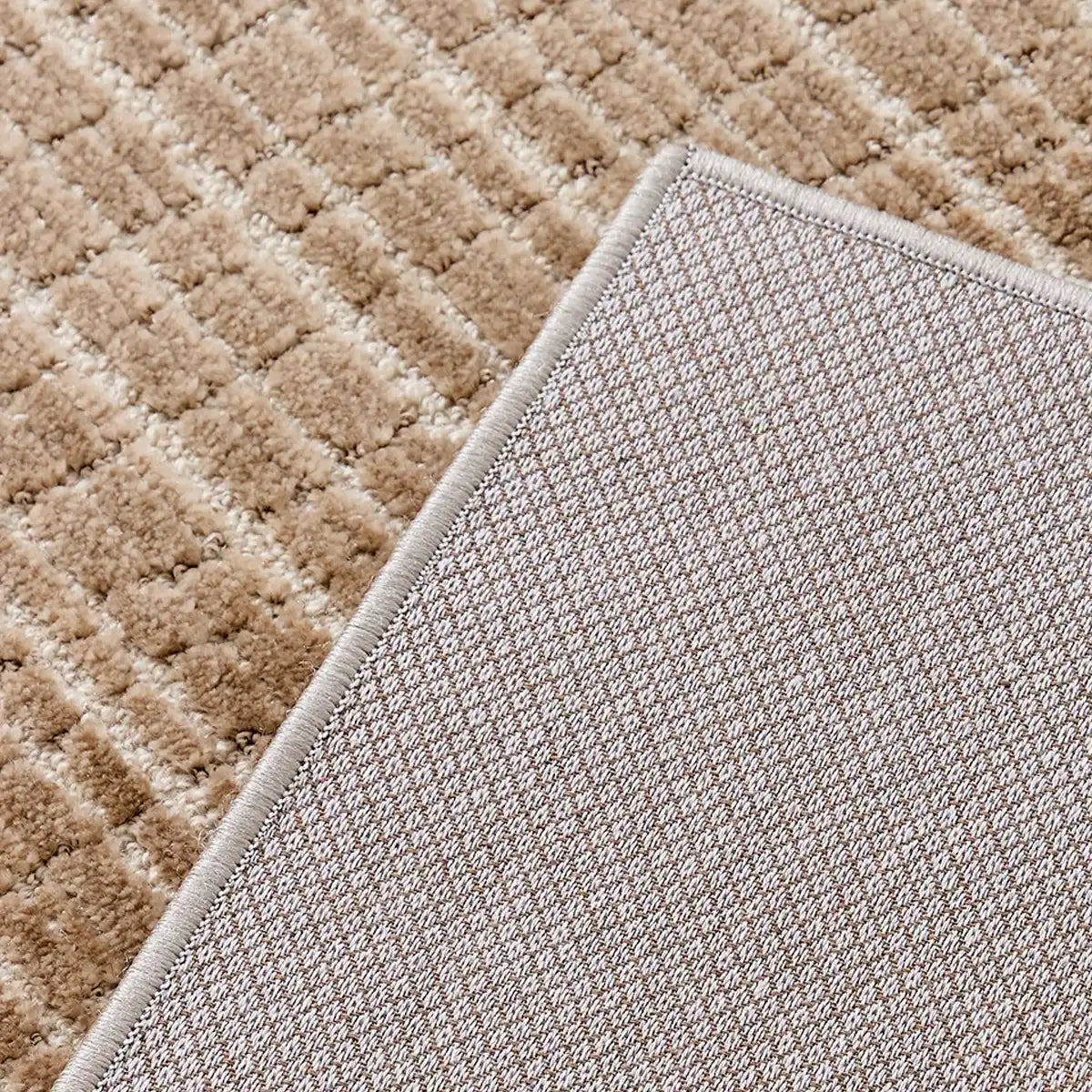 Back of the Siena textured rug showing the woven backing and finished bound edge