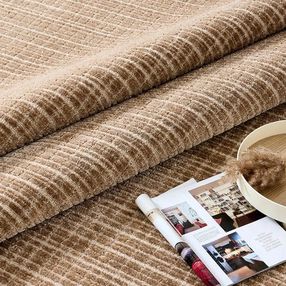 Close-up of the Siena wool blend rug showing raised linear texture in light brown and beige