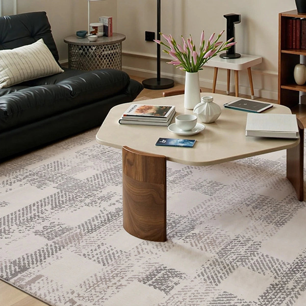 soft cream geometric rug under a coffee table in a modern living room by Tervannor