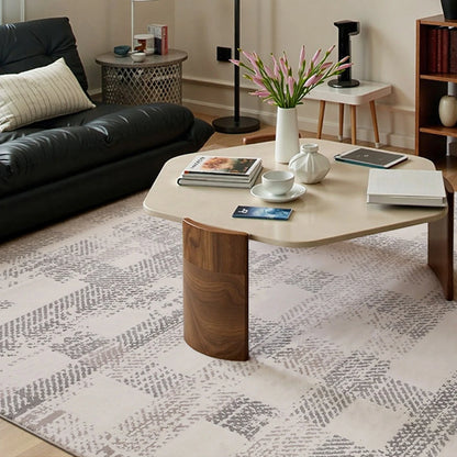 soft cream geometric rug under a coffee table in a modern living room by Tervannor