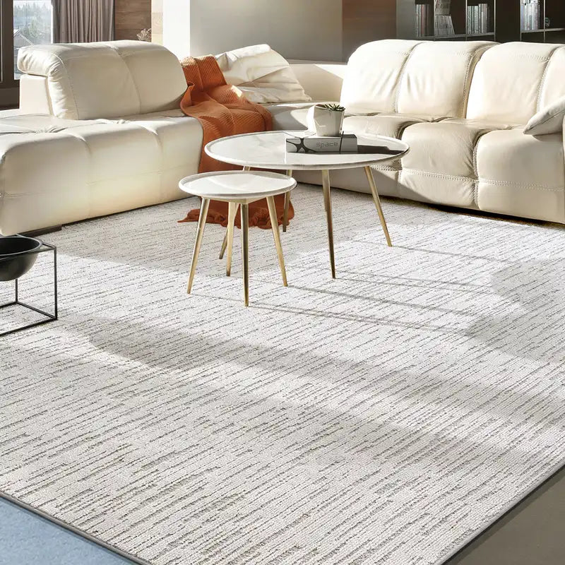 Neutral modern rug in a cozy living room with a beige sofa and minimalist coffee tables #Texture_Stripe
