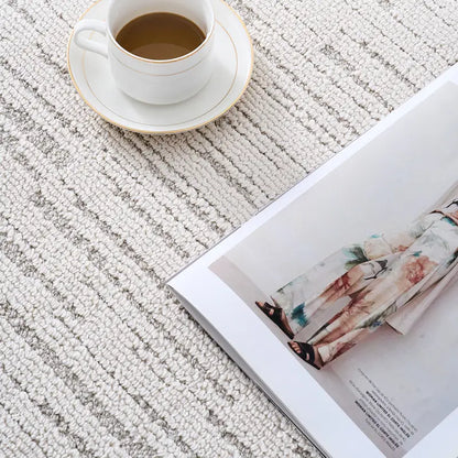 textured neutral rug thick soft stain resistant easy to clean woven close up beige striped with coffee cup