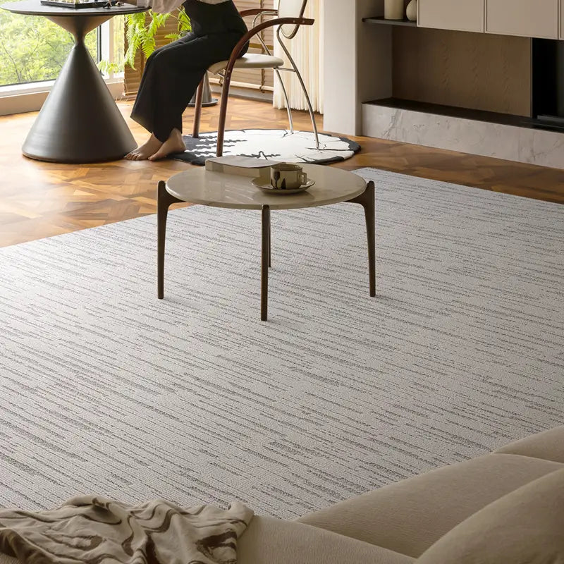 Neutral striped rug in a modern home, featuring a cozy and elegant setting with natural lighting and minimalist furniture #Texture_Stripe