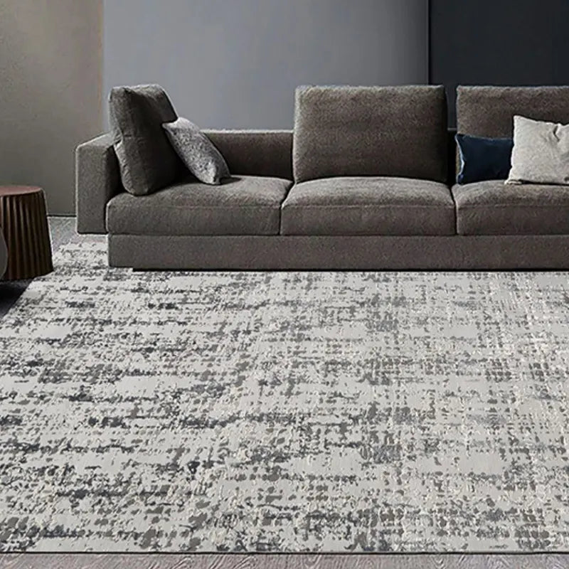 Gray textured area rug in a contemporary living room with a dark gray sofa and neutral decor