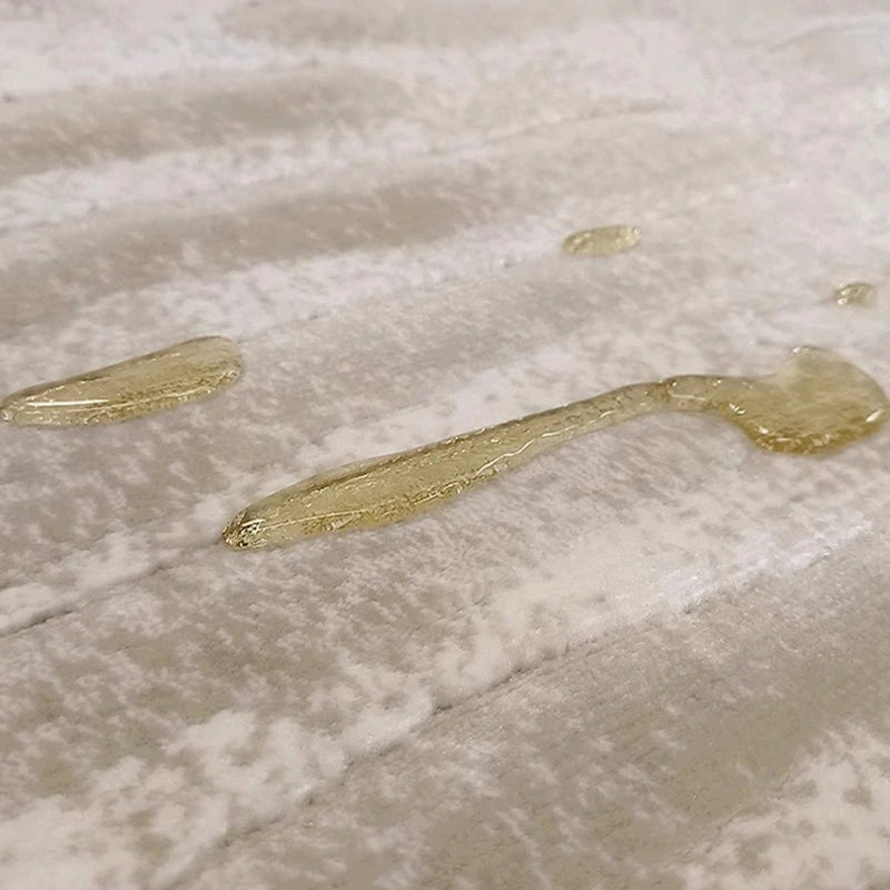 Close-up of waterproof beige area rug with liquid-resistant surface, showcasing advanced stain protection and easy cleaning