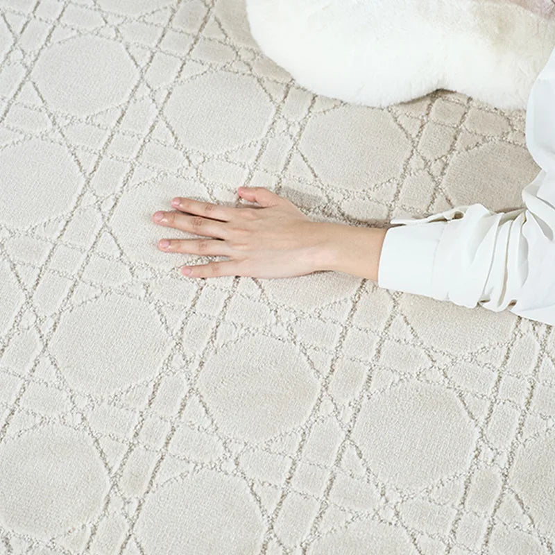 Hand feeling the soft texture of a white rug with a diamond pattern, highlighting its gentle surface#Texture_Crosshatch