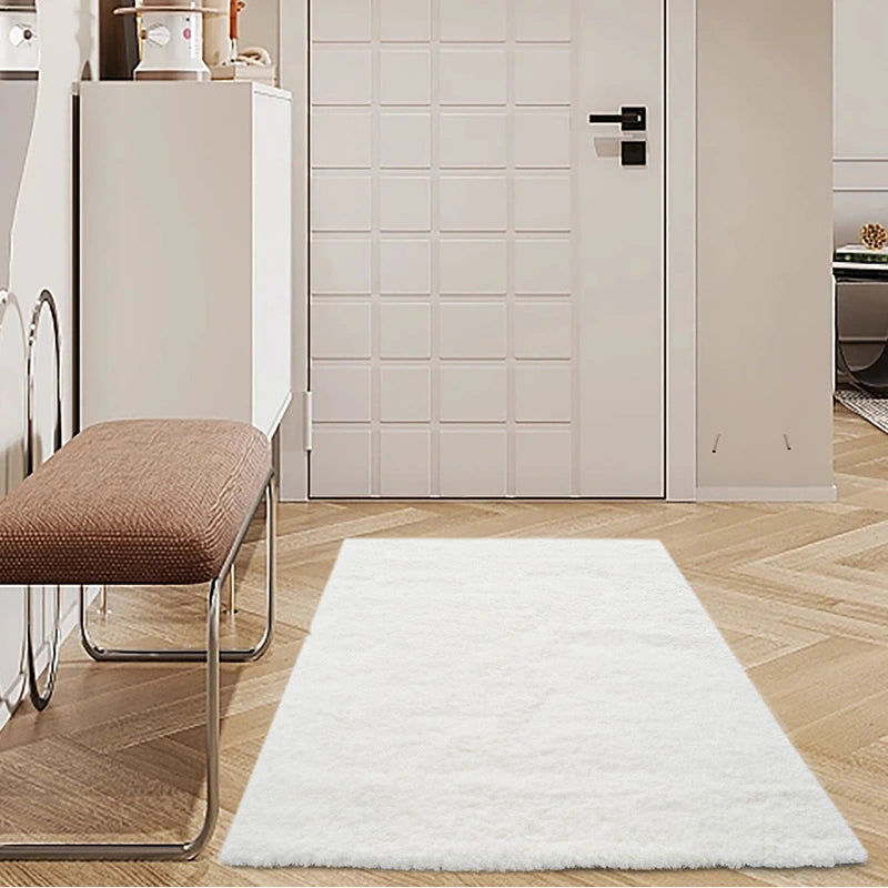 Soft white shaggy rug placed in a modern entryway with minimalistic decor, enhancing the clean and stylish atmosphere #color_Ivory White