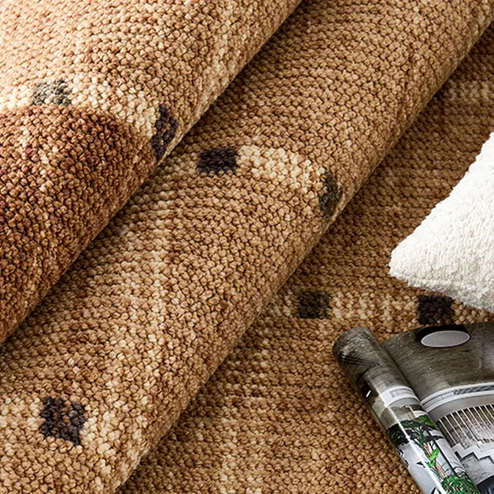 Close-up of wool blend area rug loop texture with rolled edges and magazine accent