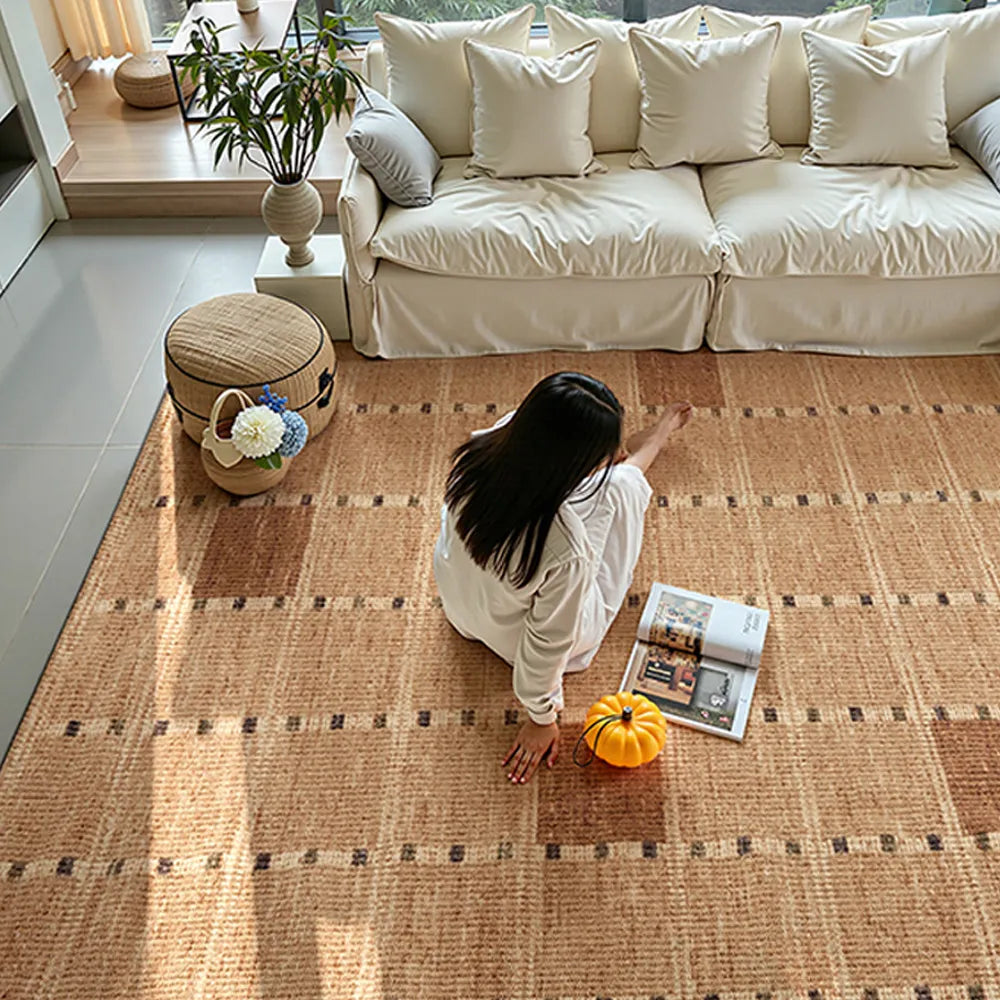 Cozy living room scene with wool blend area rug under autumn light, woman reading beside pumpkin and magazine