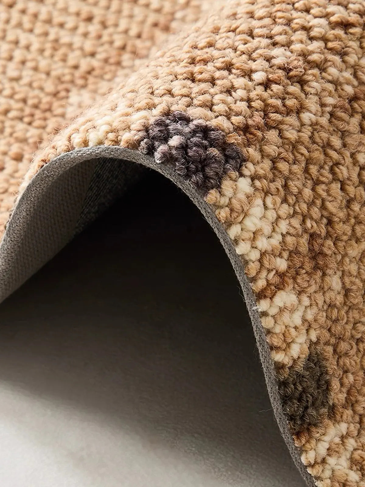 Curved detail of wool blend area rug showing 12mm thick loop weave and soft texture