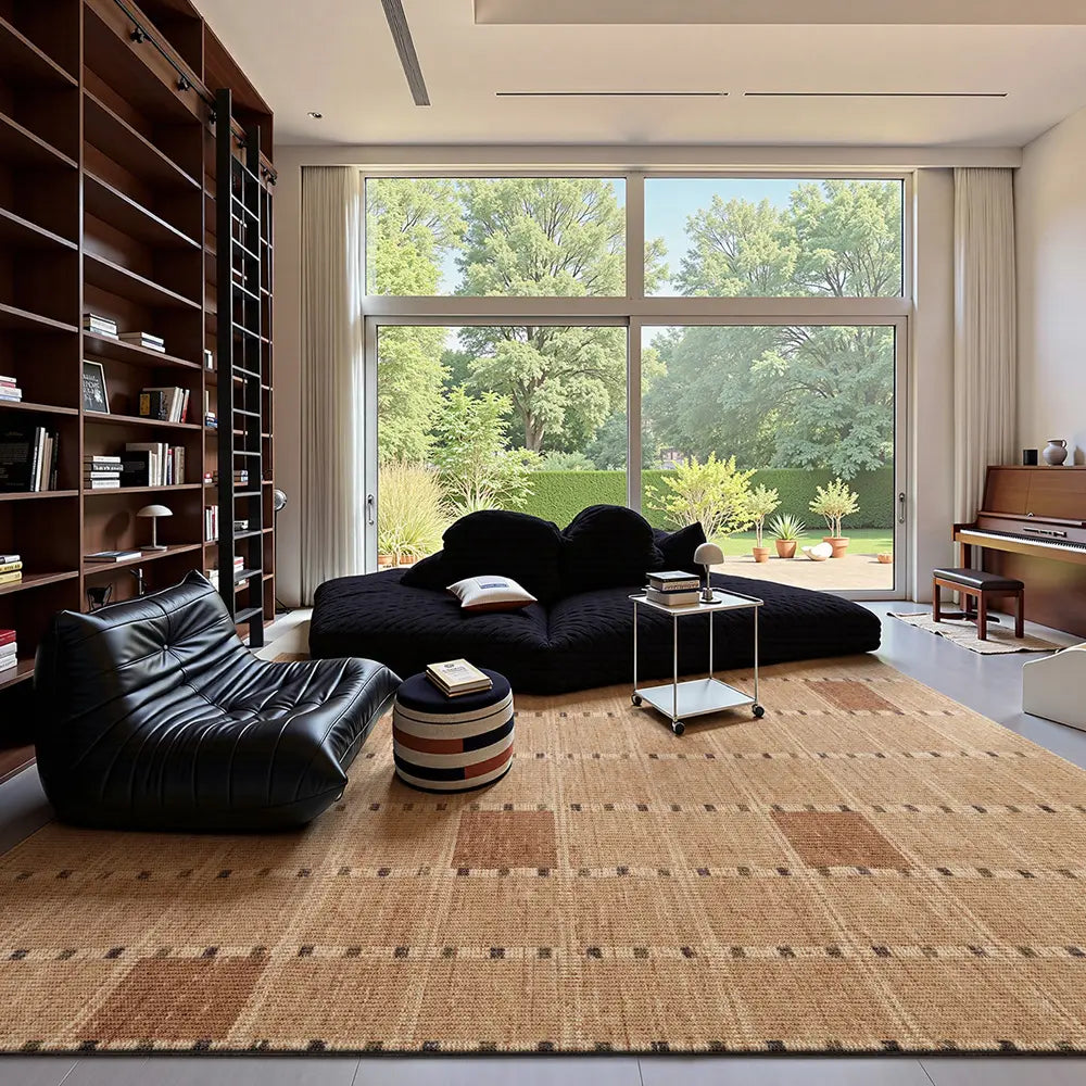 Wool blend area rug in modern reading room, warm neutral plaid pattern with black sofa and bookshelf